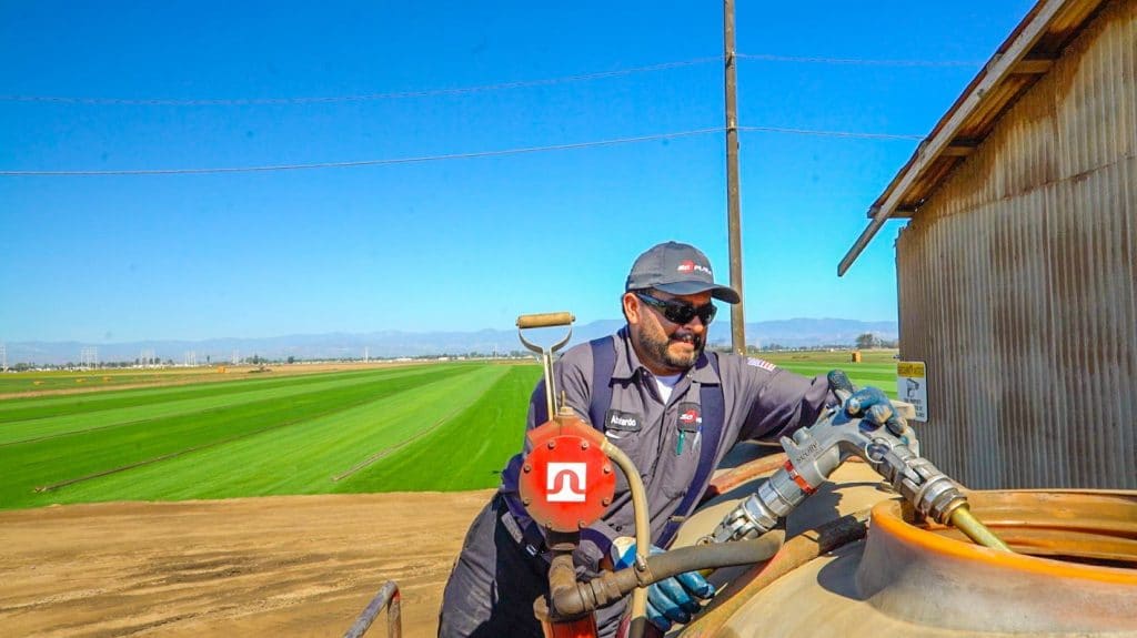 a fuel tank being filled with gas on a farm