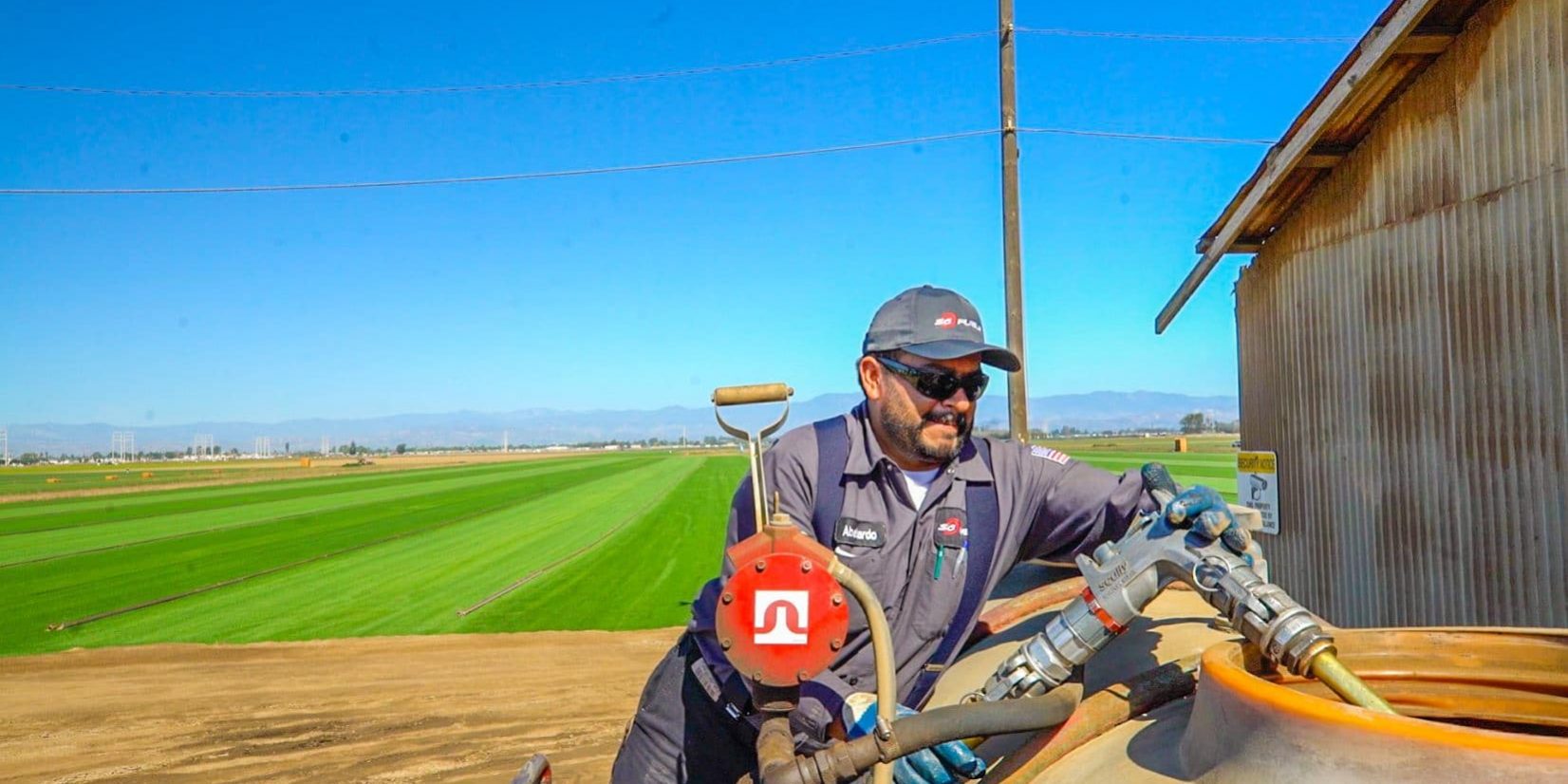 a fuel tank being filled with gas on a farm